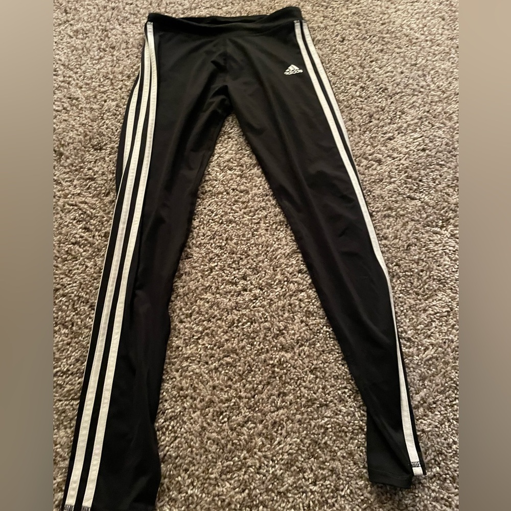 Black adidas pants with 2 white lines on the side